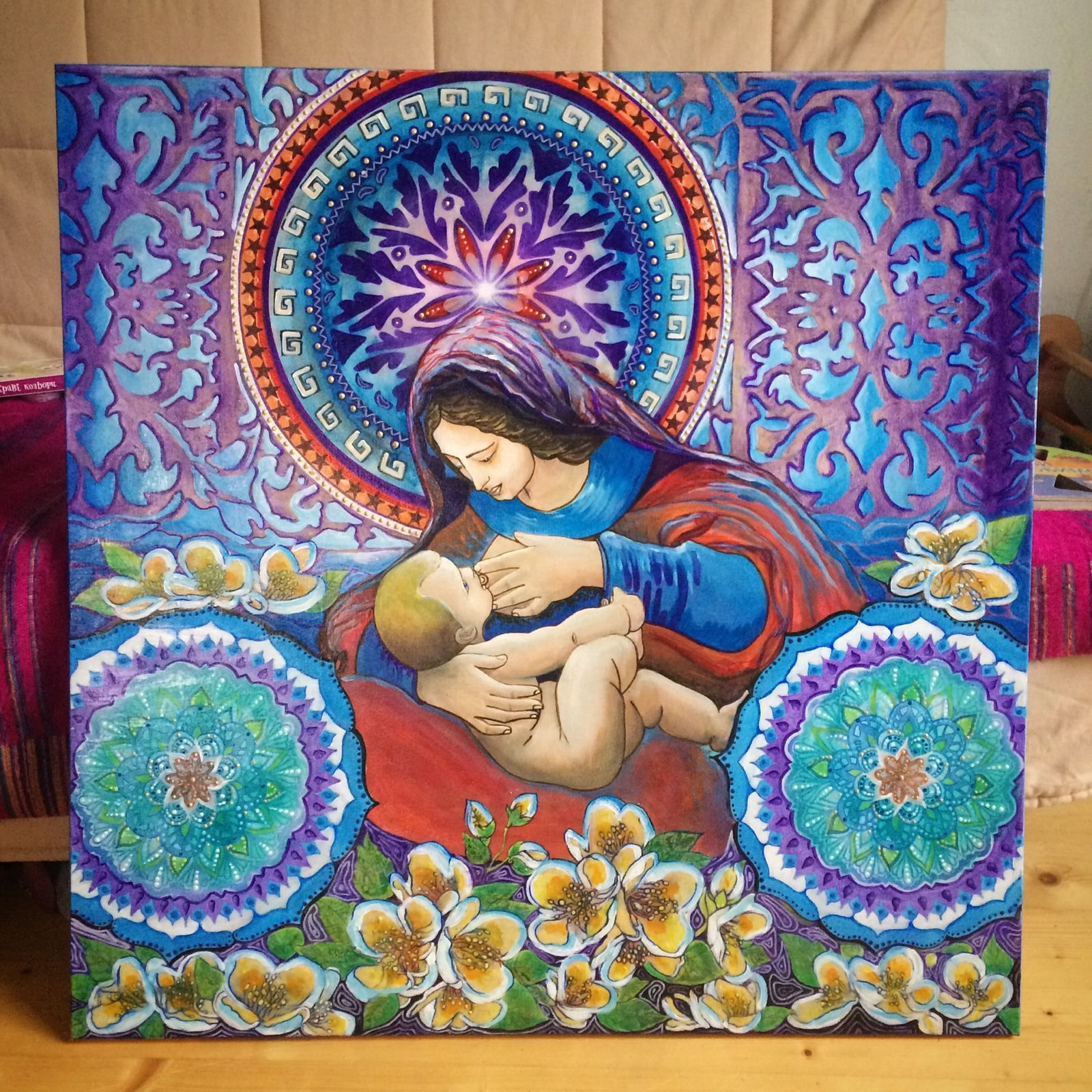 Sacred mother and child with mandala halos and flowers